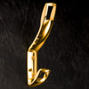 Kleiderhaken in Gold Optik an Wand hängend